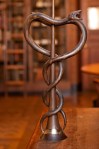 A wooden caduceus symbol shown in NYAM rare book reading room