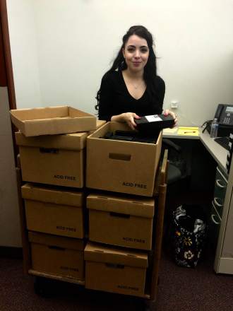 Intern Michelle Krause with audio-visual materials in the library's collection.