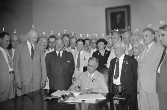 Roosevelt signing the Social Security Act, 1935. See here for names of participants. Courtesy of the Social Security Administration.