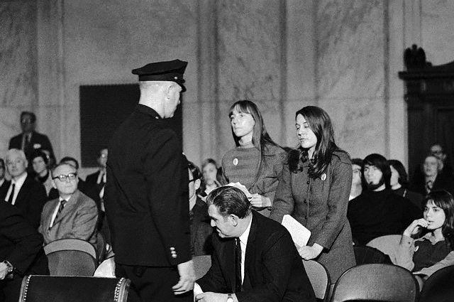 Policeman Approaching Young Feminists